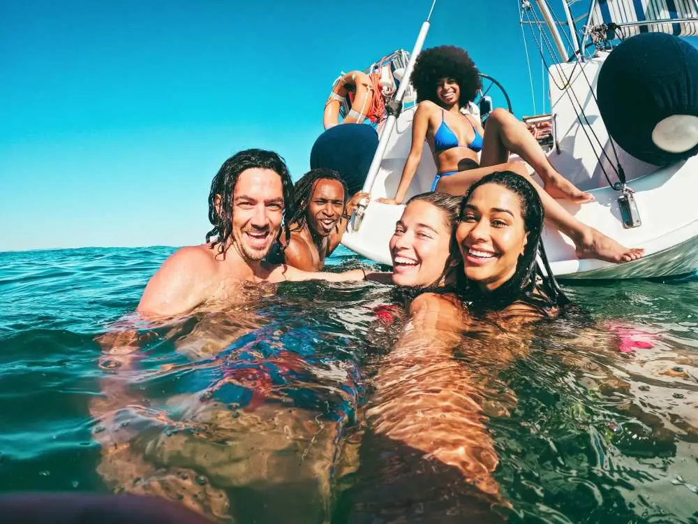 Friends enjoying a swim beside a boat